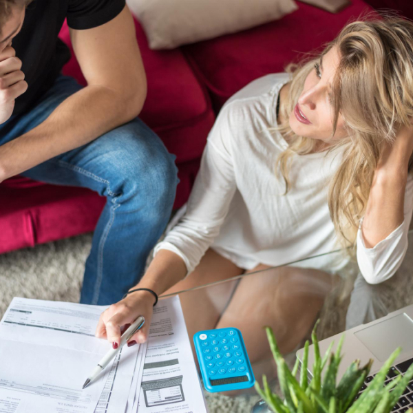 Person reviewing bills and calculating personal loan costs
